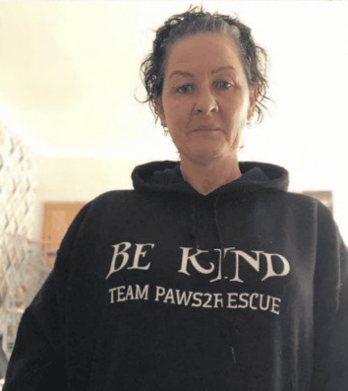 Photo of Paws2Rescue team member Kelly wearing a hoodie with the words "Be Kind, Team Paws2Rescue" printed on the front